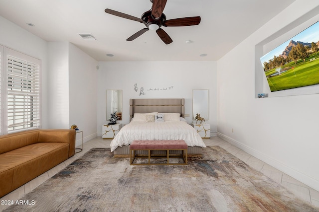 bedroom with baseboards, visible vents, and a ceiling fan