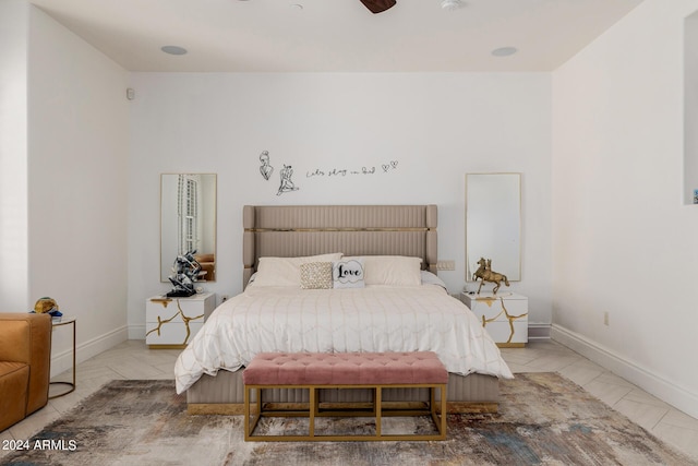 bedroom with ceiling fan and baseboards