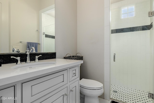 full bath with tasteful backsplash, a stall shower, vanity, and toilet