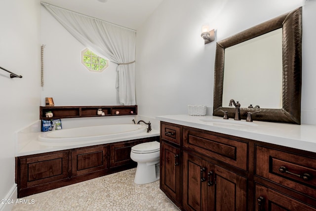 bathroom featuring toilet, a bath, and vanity