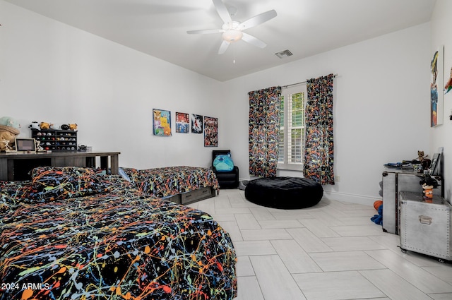 bedroom featuring a ceiling fan, visible vents, and baseboards