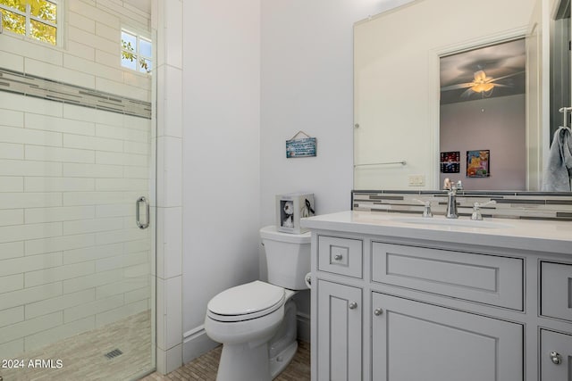 bathroom with vanity, tasteful backsplash, a shower stall, and toilet