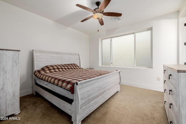 carpeted bedroom with a ceiling fan, visible vents, and baseboards