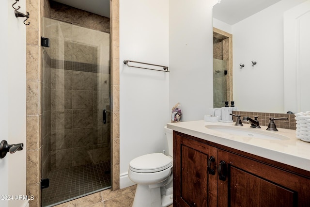 bathroom with vanity, backsplash, a shower stall, and toilet