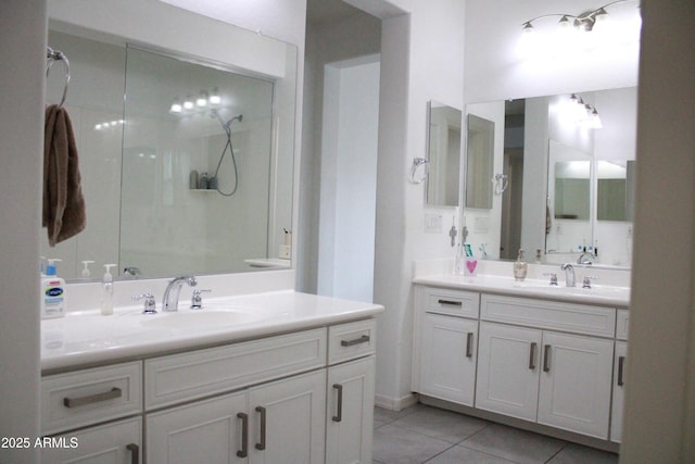 bathroom with walk in shower, tile patterned floors, and vanity