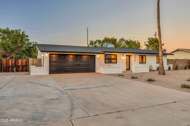 4910 E Shaw Butte Dr, Scottsdale, AZ 85254 - view of front of house with a garage, driveway, stucco siding, and a shingled roof