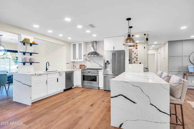 4910 E Shaw Butte Dr, Scottsdale, AZ 85254 - kitchen featuring wall chimney range hood, stainless steel appliances, a peninsula, a sink, and hanging light fixtures