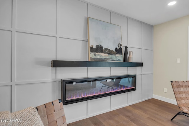 4910 E Shaw Butte Dr, Scottsdale, AZ 85254 - detailed view of a glass covered fireplace, wood finished floors, baseboards, and recessed lighting