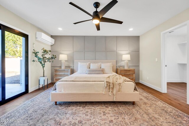 4910 E Shaw Butte Dr, Scottsdale, AZ 85254 - bedroom featuring a wall mounted air conditioner, access to exterior, baseboards, wood finished floors, and recessed lighting