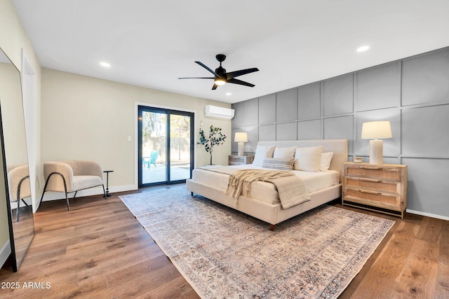 4910 E Shaw Butte Dr, Scottsdale, AZ 85254 - bedroom with a wall mounted air conditioner, access to exterior, wood finished floors, baseboards, and recessed lighting