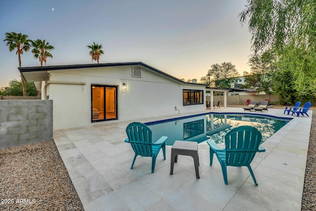 4910 E Shaw Butte Dr, Scottsdale, AZ 85254 - pool at dusk featuring a patio area and a fenced backyard