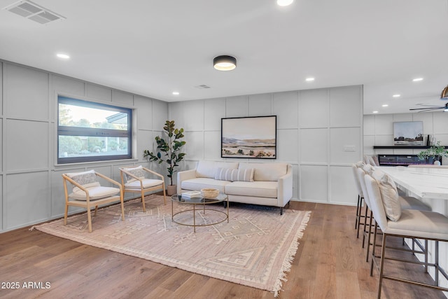 4910 E Shaw Butte Dr, Scottsdale, AZ 85254 - living area featuring a decorative wall, wood finished floors, a ceiling fan, and recessed lighting