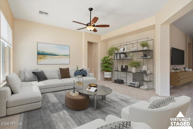 carpeted living room with ceiling fan