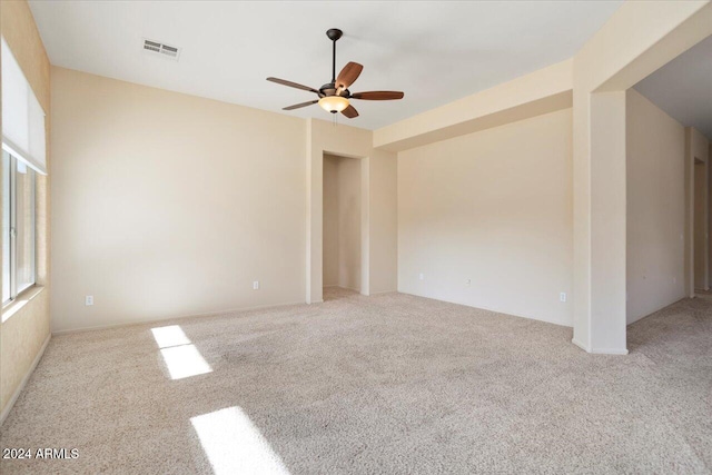 carpeted empty room featuring ceiling fan