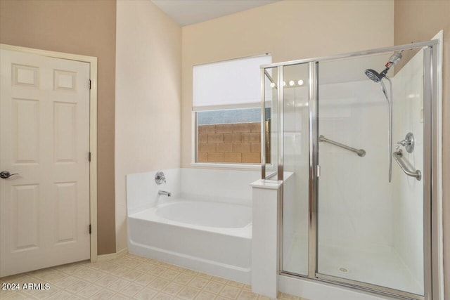 bathroom featuring separate shower and tub