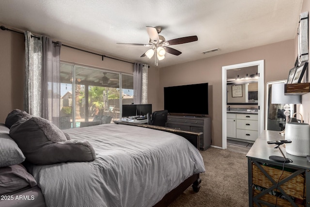 bedroom featuring ensuite bath, access to exterior, carpet, a ceiling fan, and visible vents