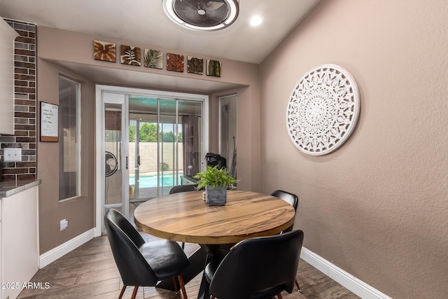 dining room featuring recessed lighting, baseboards, and wood finished floors