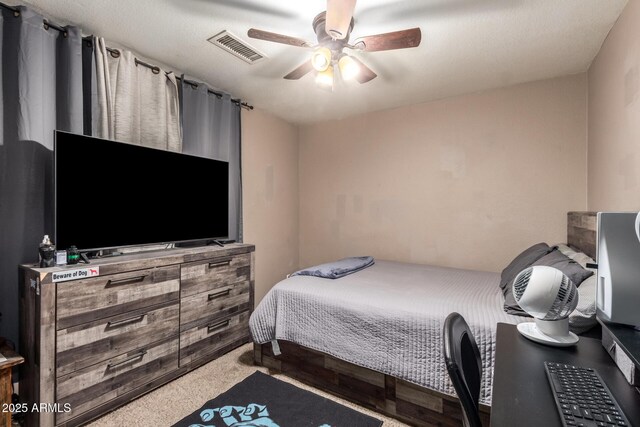 carpeted bedroom featuring ceiling fan and visible vents