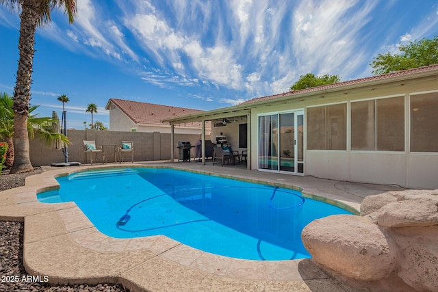 view of pool featuring a fenced backyard, a fenced in pool, a patio, and area for grilling