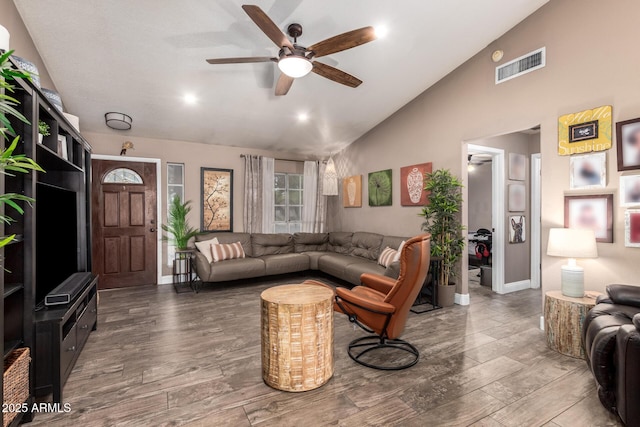 living room featuring visible vents, wood finished floors, baseboards, high vaulted ceiling, and a ceiling fan