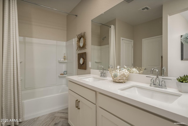 bathroom featuring shower / bath combination with curtain, parquet flooring, and vanity