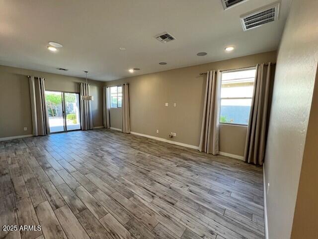 17066 W Seldon Ln, Waddell, AZ 85355 - unfurnished room with wood finished floors, baseboards, and recessed lighting