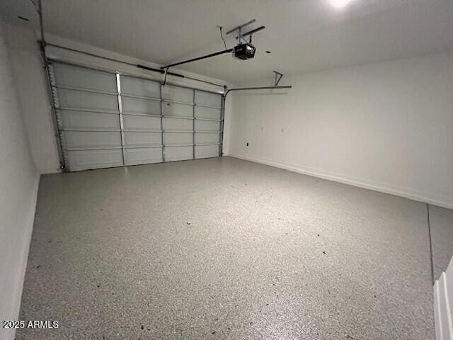 17066 W Seldon Ln, Waddell, AZ 85355 - garage with a garage door opener and baseboards