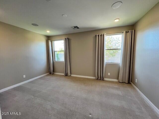17066 W Seldon Ln, Waddell, AZ 85355 - empty room with light carpet and baseboards
