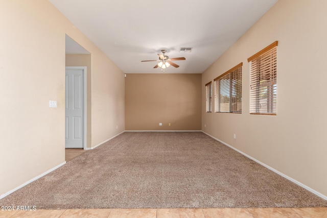 carpeted empty room featuring ceiling fan