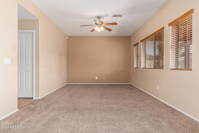 carpeted empty room with ceiling fan