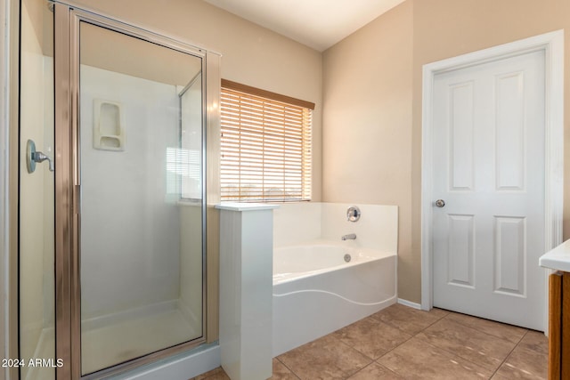 bathroom with tile patterned flooring, vanity, and separate shower and tub