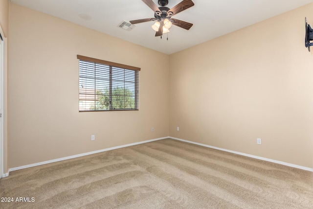 spare room with ceiling fan and carpet floors