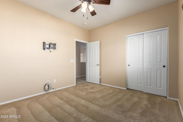 unfurnished bedroom with carpet floors, a closet, and ceiling fan