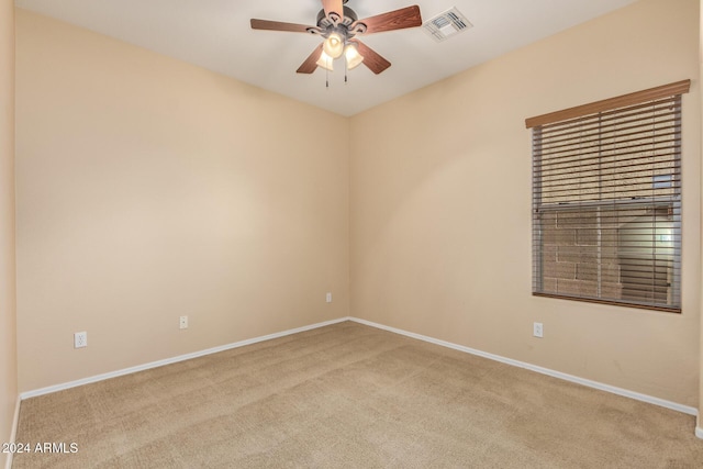 empty room featuring light carpet and ceiling fan