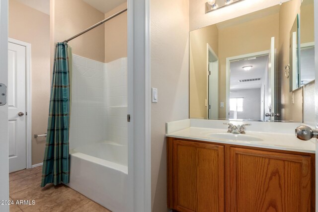 bathroom featuring tile patterned flooring, shower / bath combination with curtain, and vanity