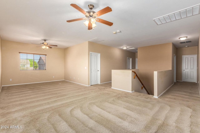 spare room with light colored carpet and ceiling fan