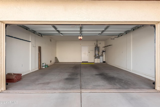 garage with a garage door opener and gas water heater