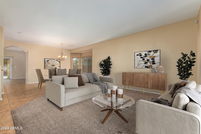 living room with an inviting chandelier and light tile patterned flooring