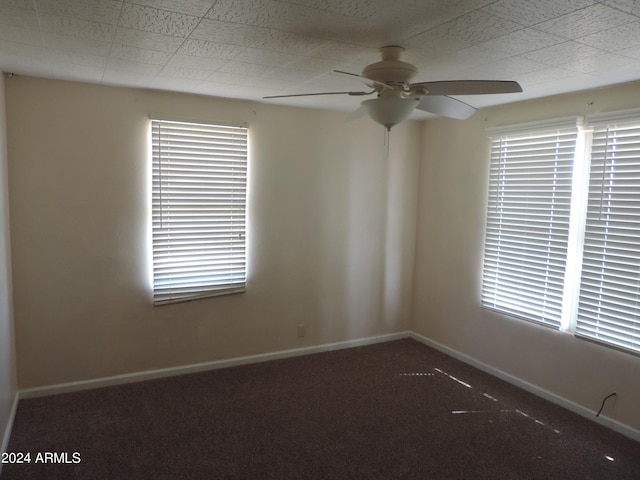 spare room featuring carpet and ceiling fan