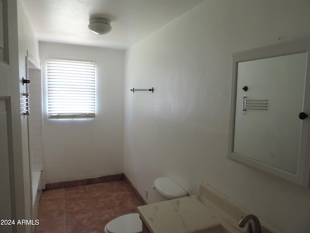 bathroom featuring vanity, toilet, and tile patterned flooring