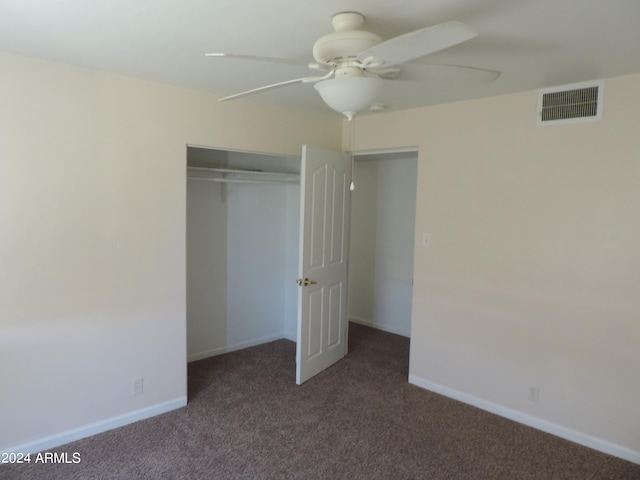 unfurnished bedroom with a closet, ceiling fan, and dark colored carpet