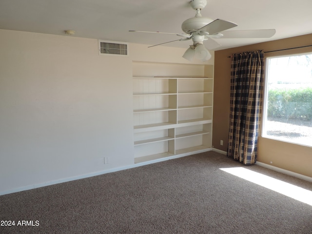 empty room with ceiling fan and carpet flooring