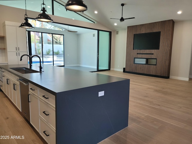 7724 E Charter Oak Rd, Scottsdale, AZ 85260 - kitchen with open floor plan, a ceiling fan, lofted ceiling, a kitchen island with sink, and white cabinets