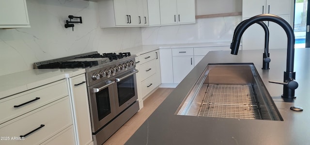 7724 E Charter Oak Rd, Scottsdale, AZ 85260 - kitchen with double oven range, tasteful backsplash, white cabinets, and light countertops