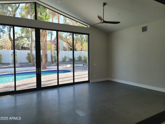 7724 E Charter Oak Rd, Scottsdale, AZ 85260 - spare room featuring vaulted ceiling, a ceiling fan, and dark tile patterned floors