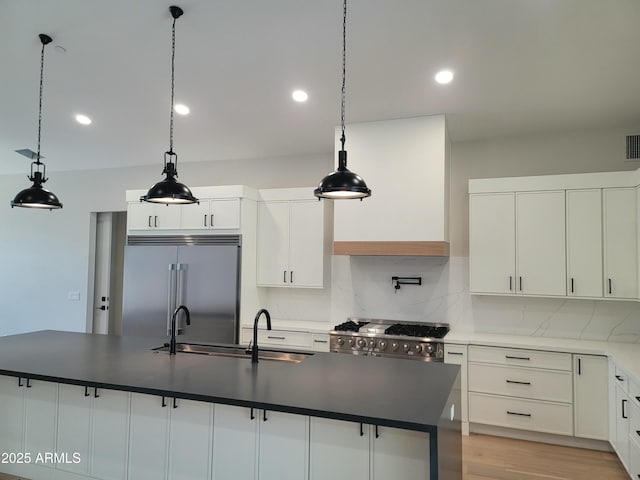 7724 E Charter Oak Rd, Scottsdale, AZ 85260 - kitchen featuring high end appliances, dark countertops, tasteful backsplash, white cabinetry, and recessed lighting