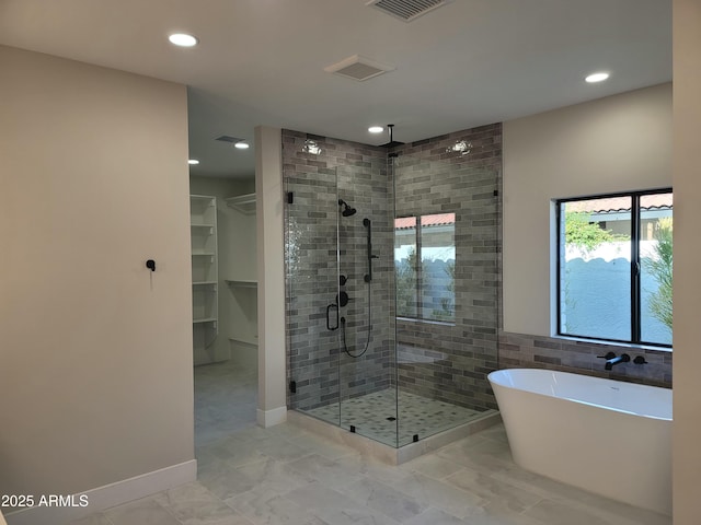 7724 E Charter Oak Rd, Scottsdale, AZ 85260 - full bath featuring a shower stall, a freestanding tub, recessed lighting, and a walk in closet