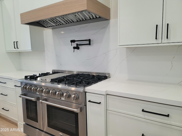 7724 E Charter Oak Rd, Scottsdale, AZ 85260 - kitchen featuring double oven range, custom exhaust hood, backsplash, white cabinets, and light stone countertops