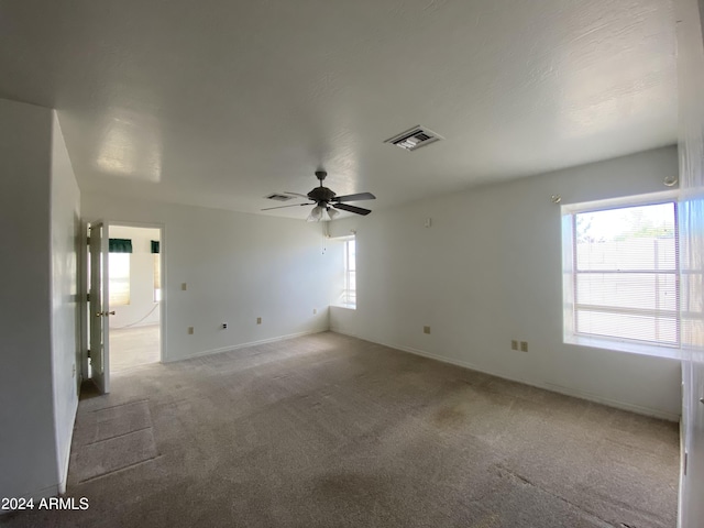 unfurnished room with ceiling fan and light colored carpet