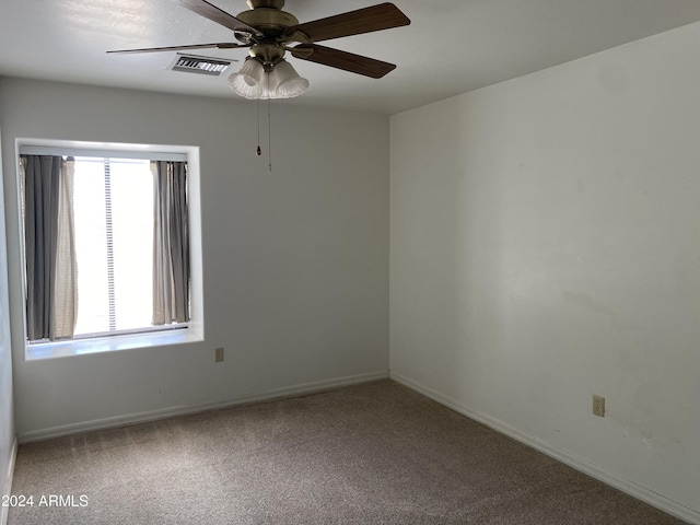 carpeted spare room with ceiling fan